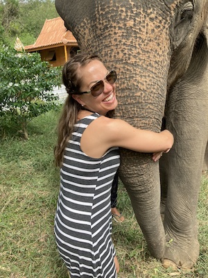 Valerie hugging elephant